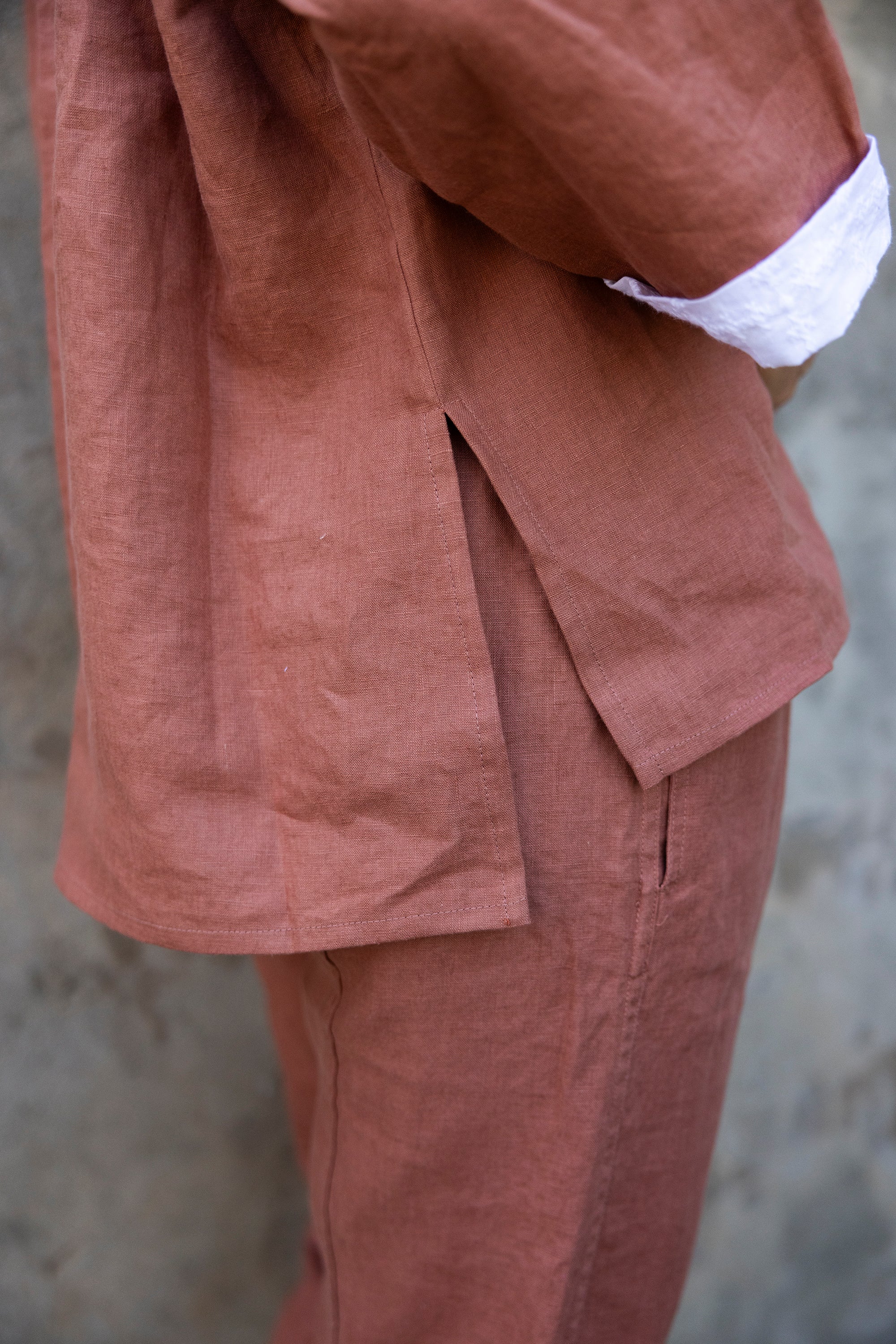 Rust coloured shirt and pants with a blurred background