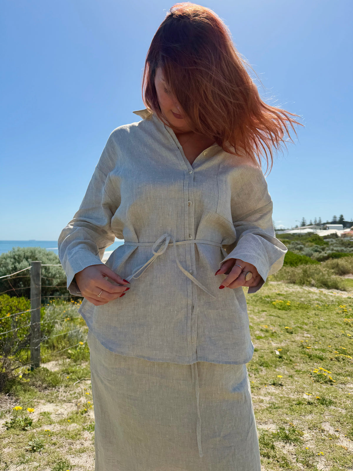 White linen two-piece outfit with V-neck button placket, drawstring waist, long skirt