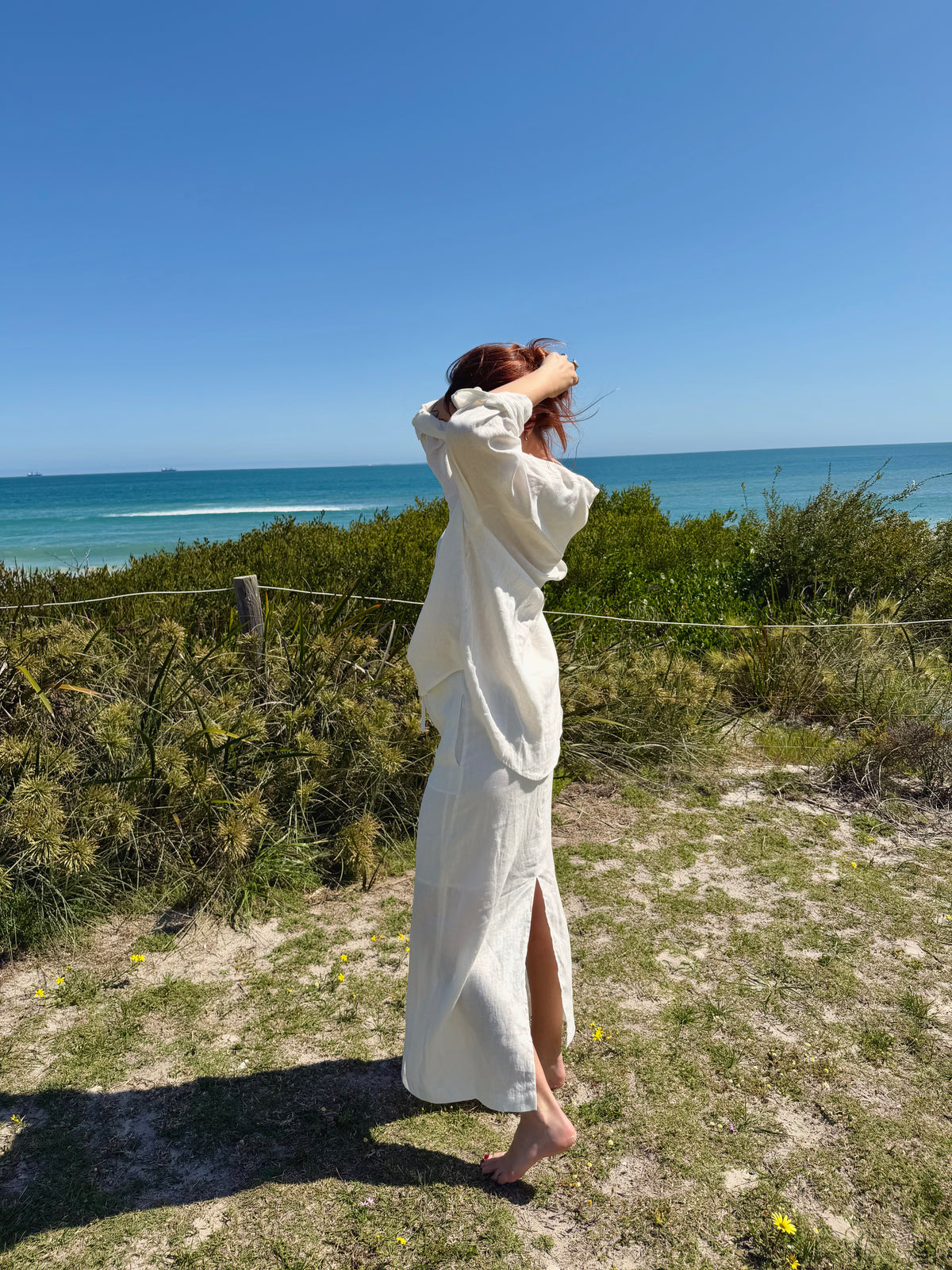 White linen two-piece outfit with button-front tunic, drawstring waist, long skirt with slit