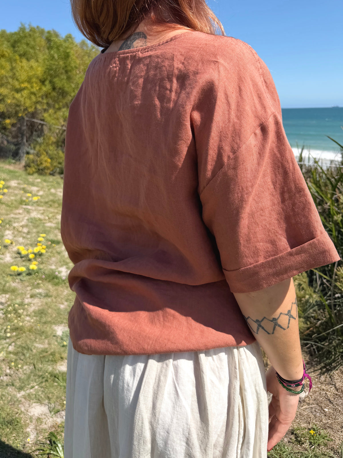 Rust boxy tee back view with short sleeves and crew neck, relaxed loose fit.