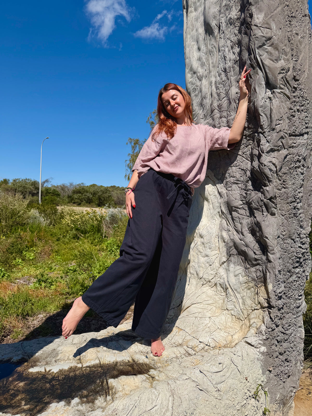 Navy barrel pants with relaxed wide legs and ankle-length silhouette