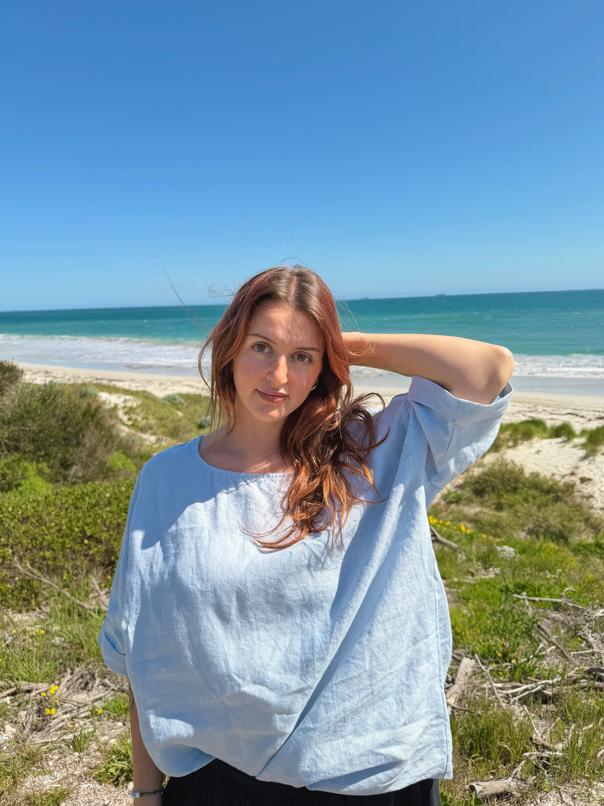 Light blue boxy tee with crew neck and short sleeves, relaxed loose fit