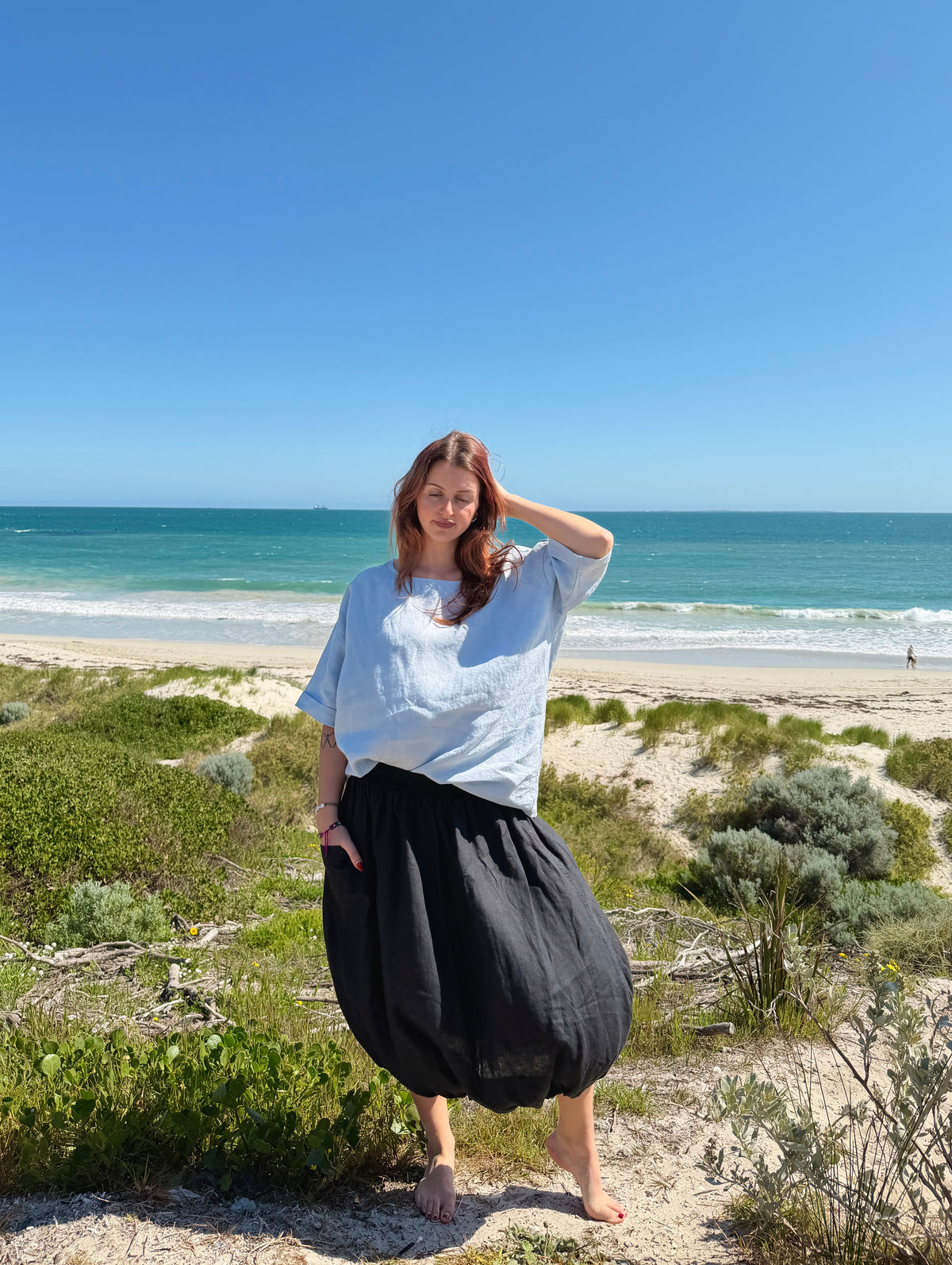 Tulip-style forage skirt in ink black, gathered midi with wide ruched tulip hem