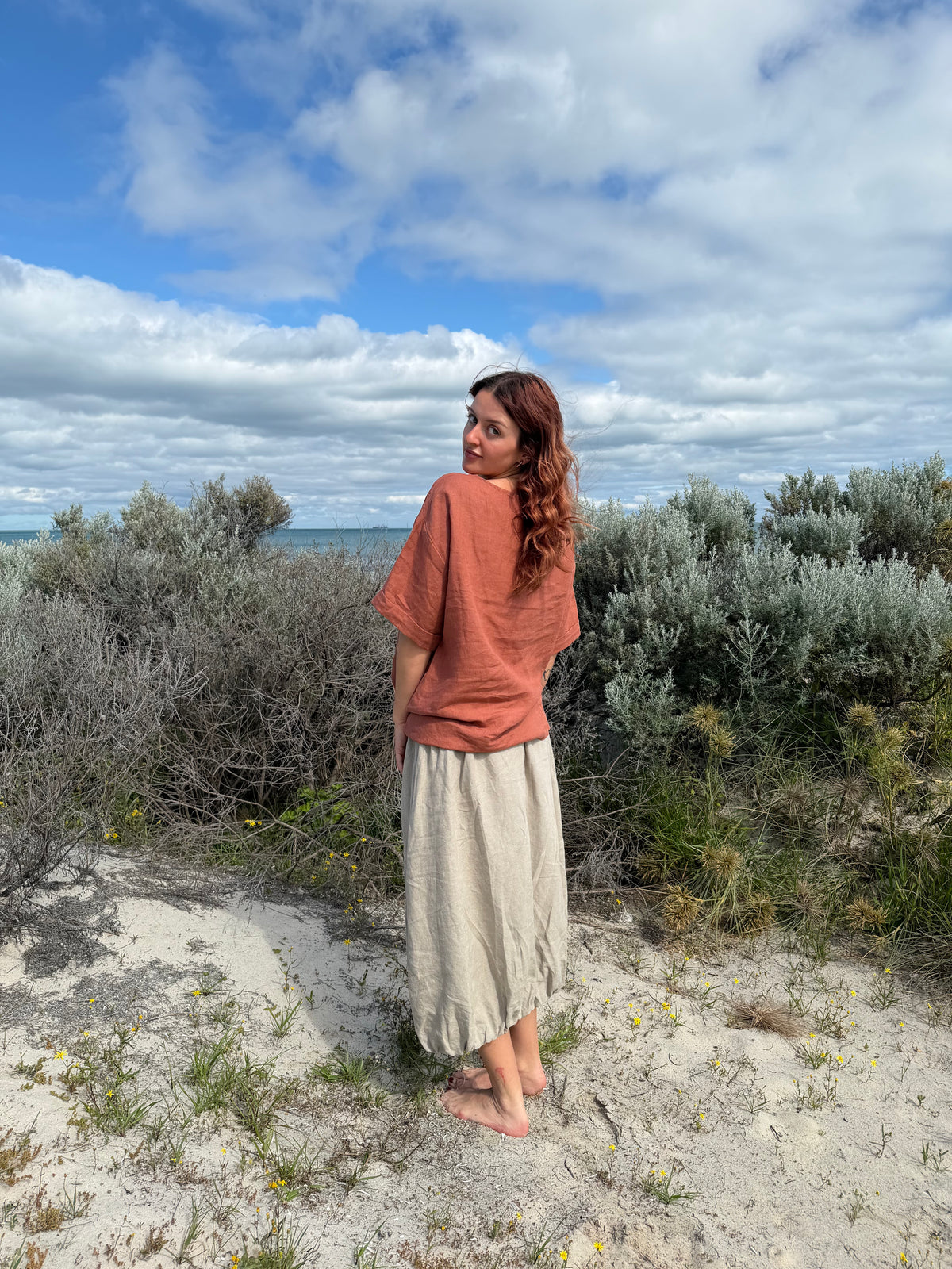 Rust boxy tee with crew neck and short sleeves, side profile