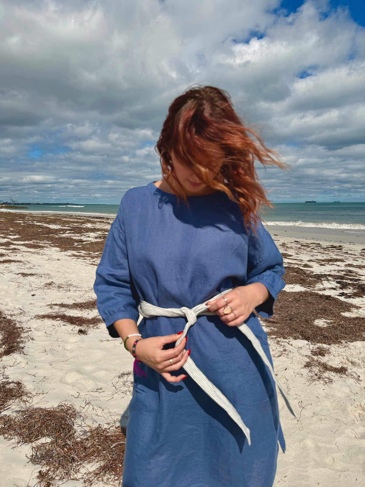 Denim blue tee tunic dress from back with tie belt at waist