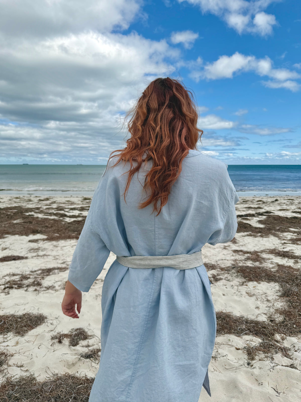 Light blue tee tunic dress from back with tie belt at waist