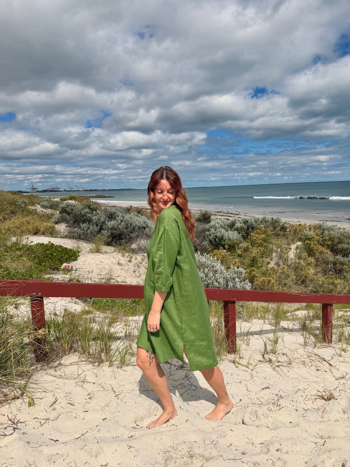 Green tee tunic dress with 3/4 sleeves and angled long hem