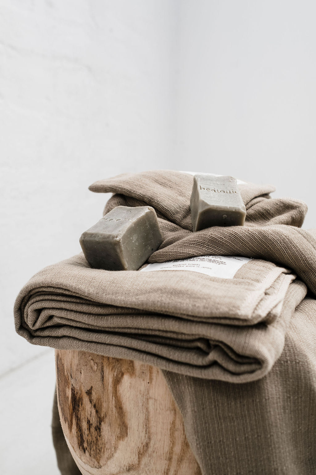 2 bars of soap with bedtonic engraved on them on a pile of grey towels