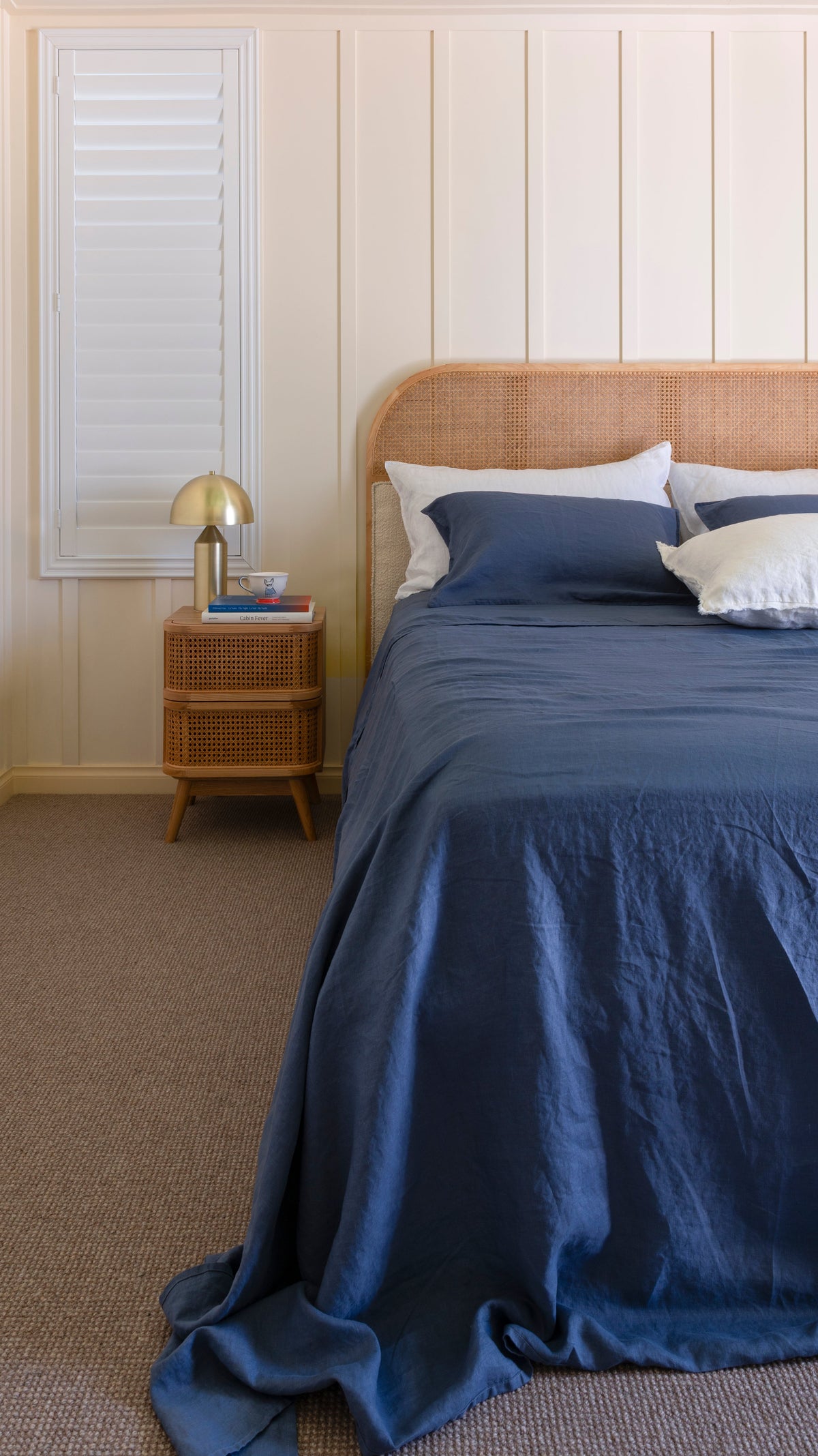 Denim blue linen sheet set with pillowcases on bed with two matching pillows