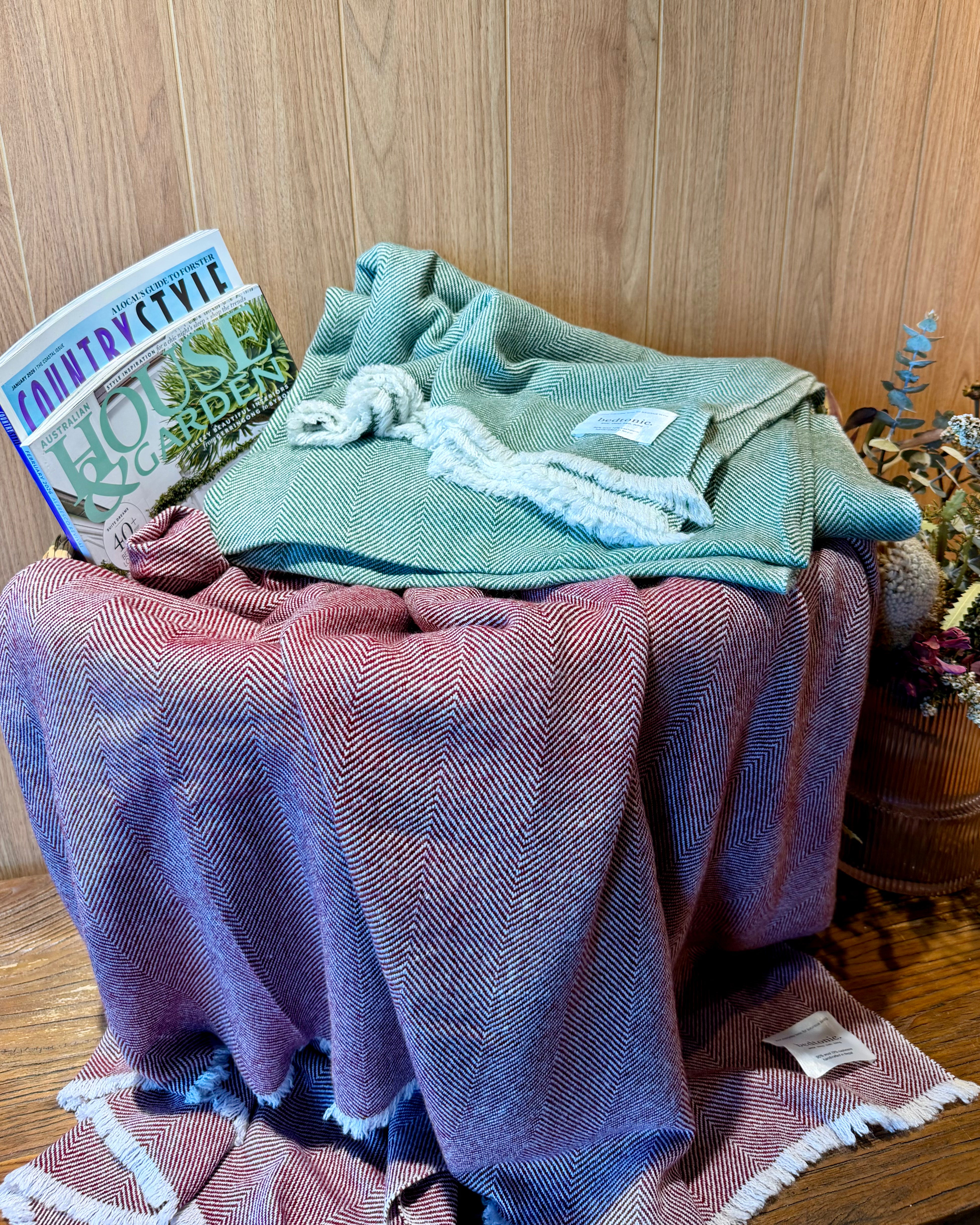 Teal and mauve wool-cashmere throws with chevron texture and fringed borders, stacked