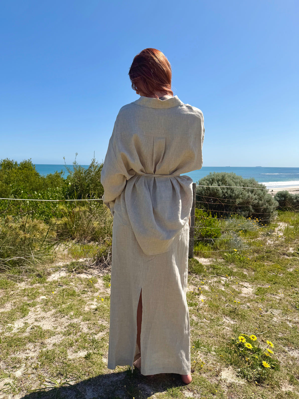 White linen two-piece outfit with button-front tunic, drawstring waist, long skirt; back view