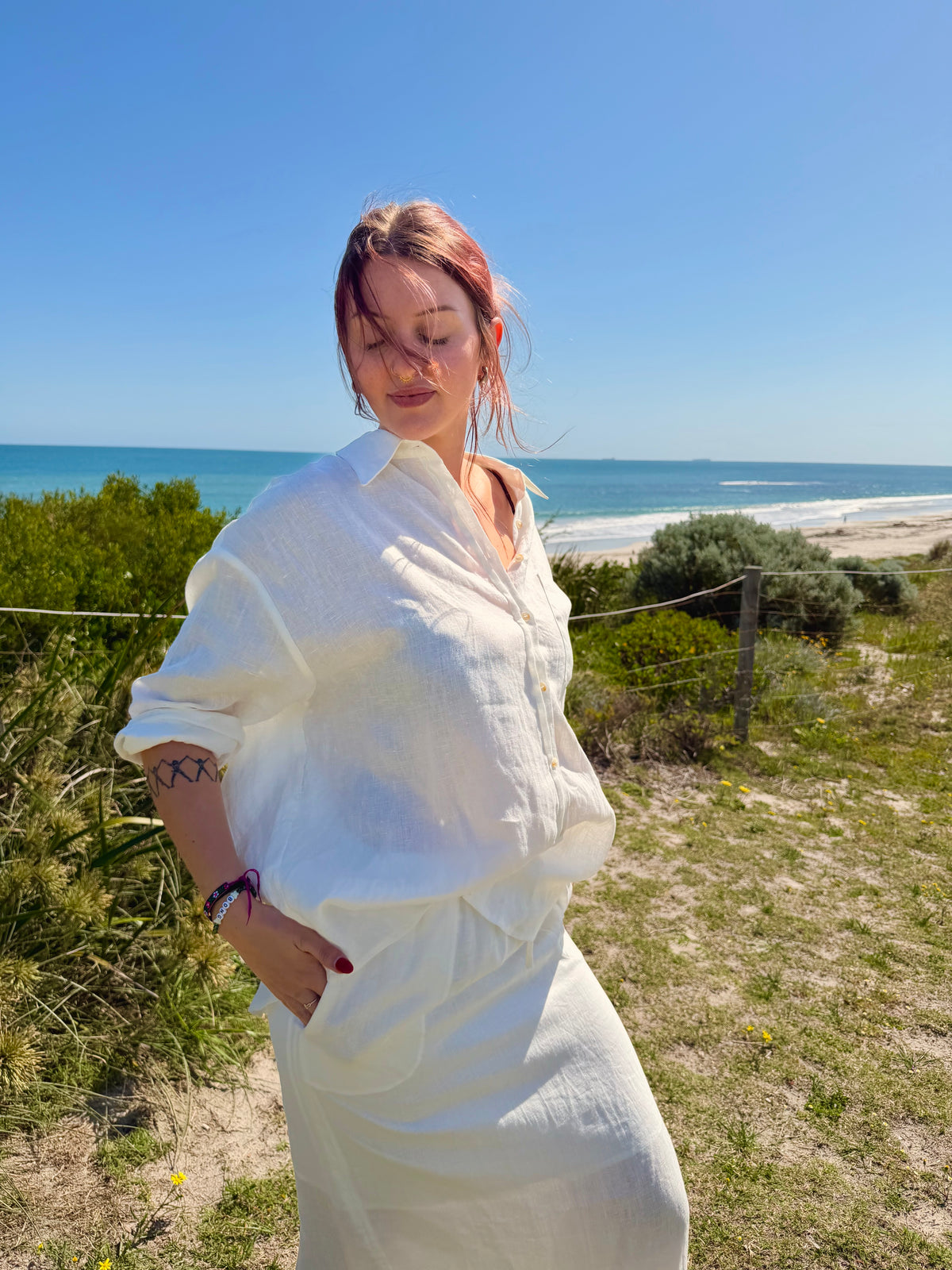 White linen two-piece outfit with button-front tunic, drawstring waist, long skirt