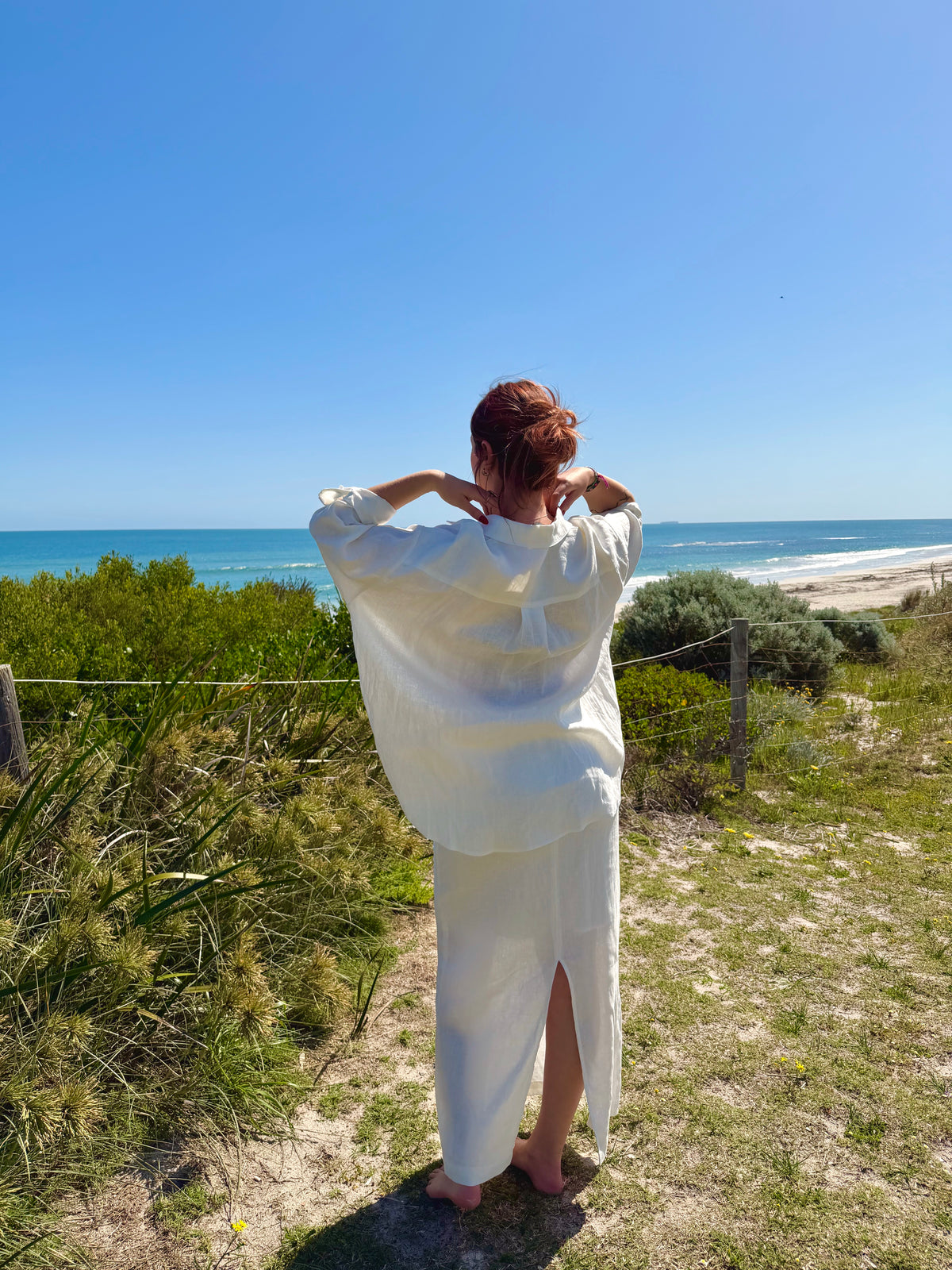 White linen two-piece with button-front tunic and drawstring waist; long skirt back view
