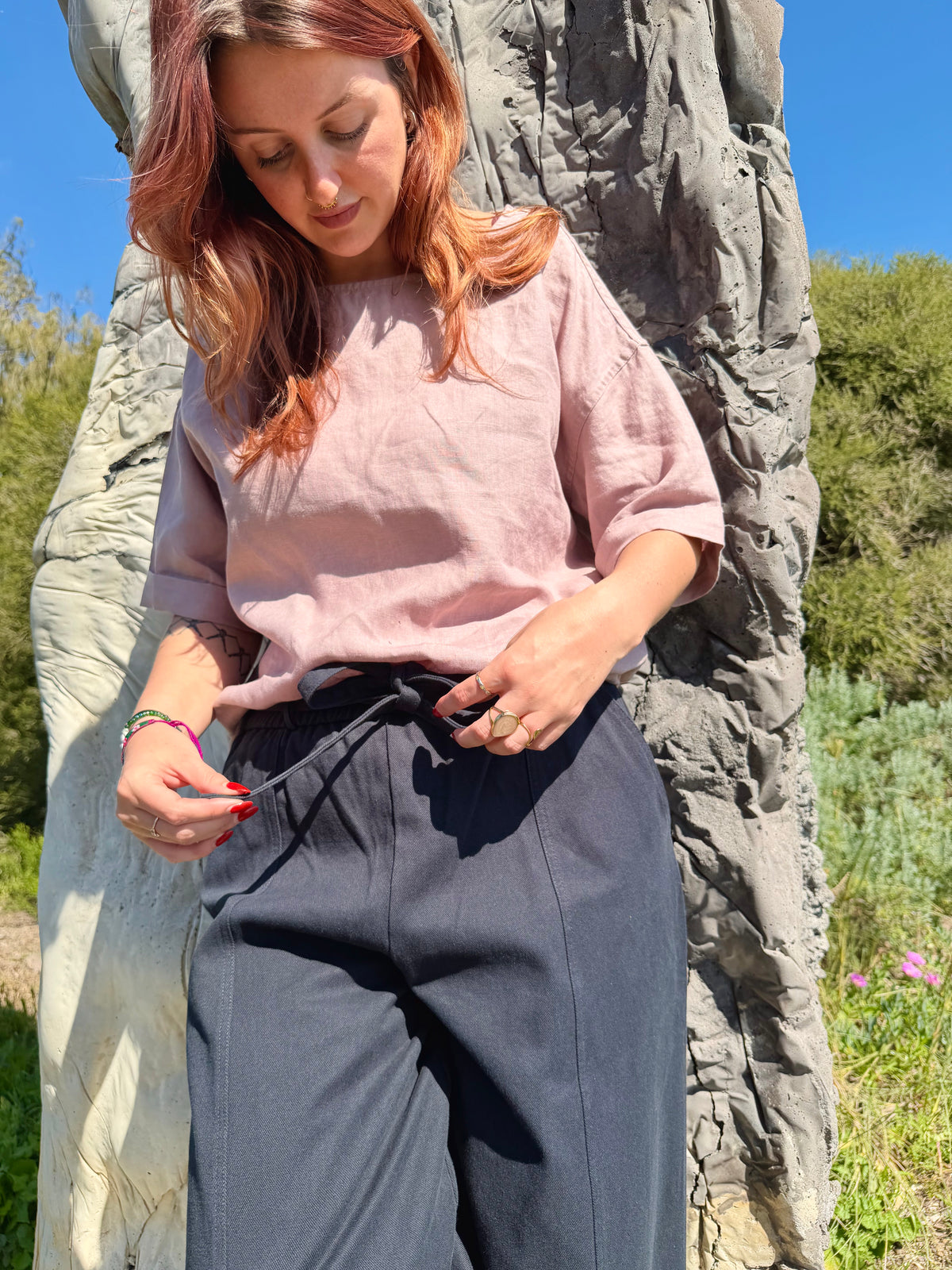Navy barrel pants with drawstring waist, wide legs, and side seams