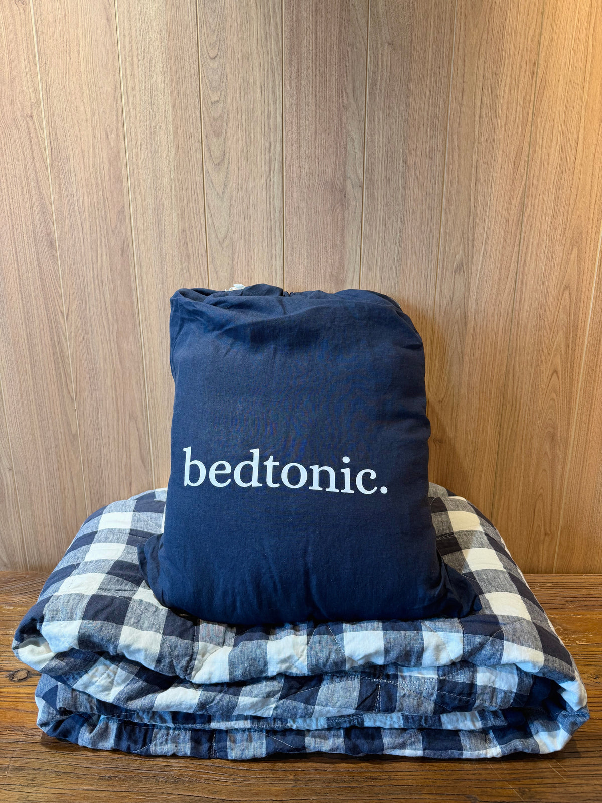 Indigo blue flax linen blanket with buffalo check pattern and stitched ruffled edge