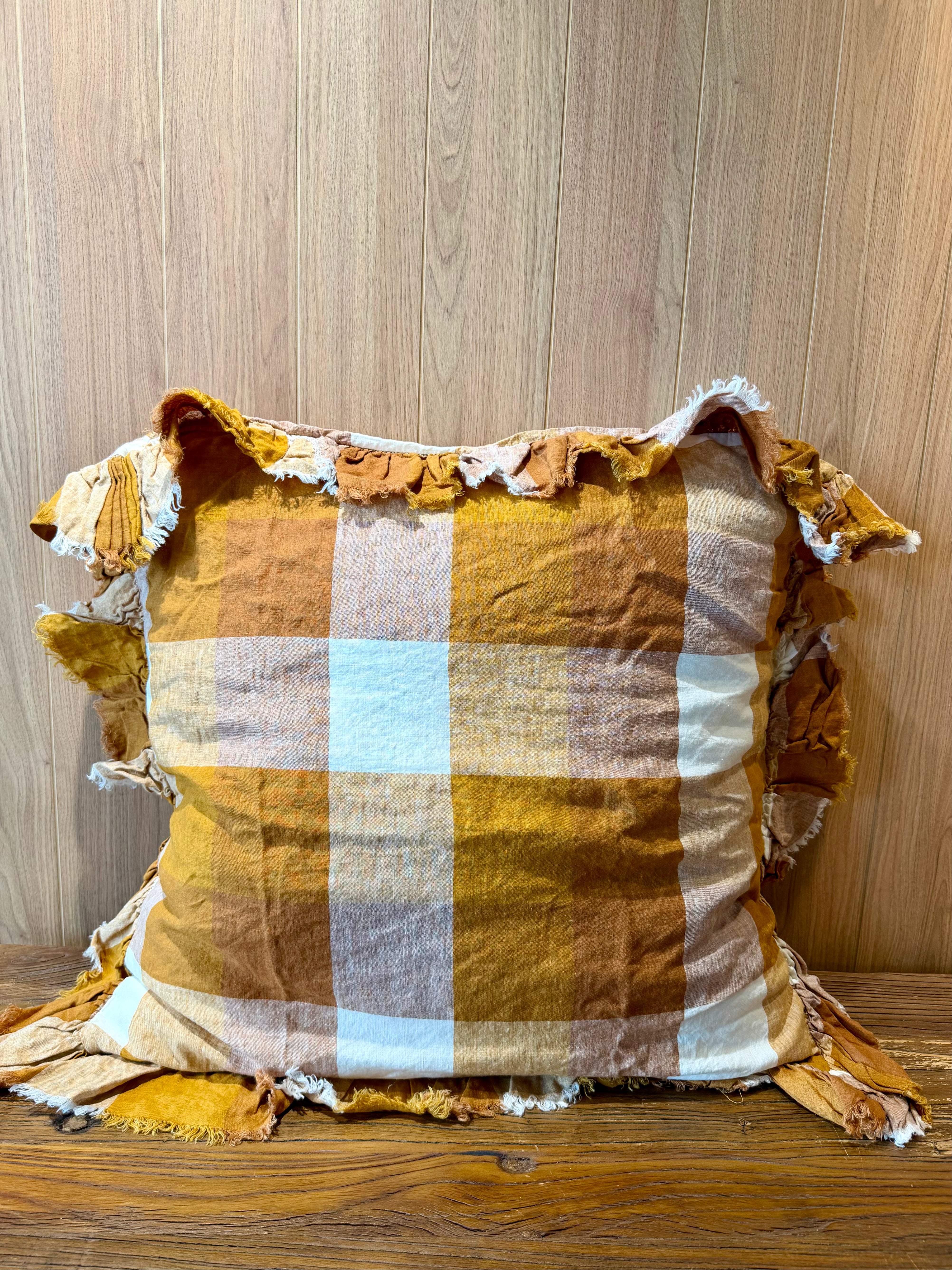 Ruffled linen pillowcase in warm terracotta, white, and light-blue check pattern