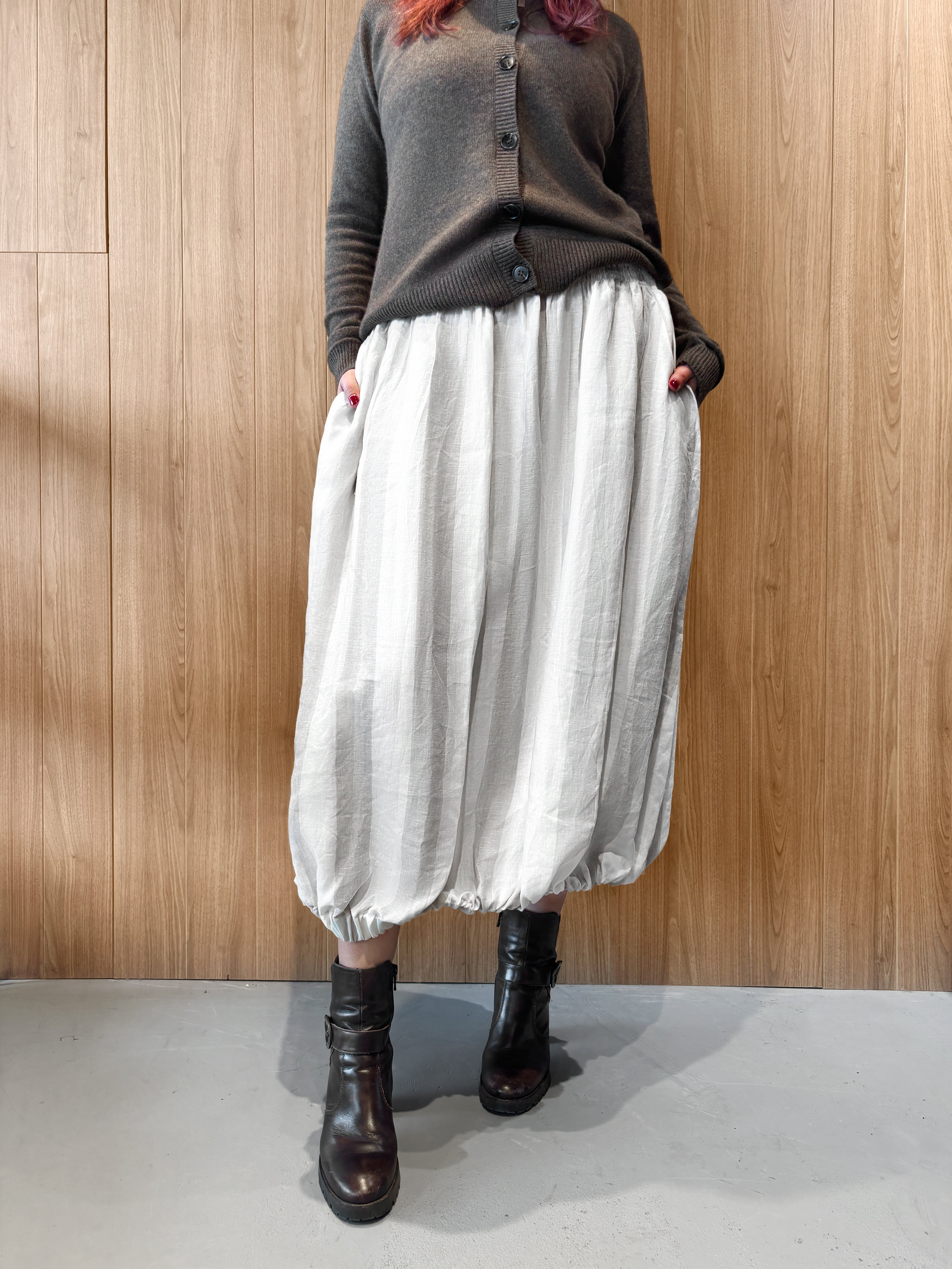 Off-white tulip-style maxi skirt with elastic waistband and gathered lower edge
