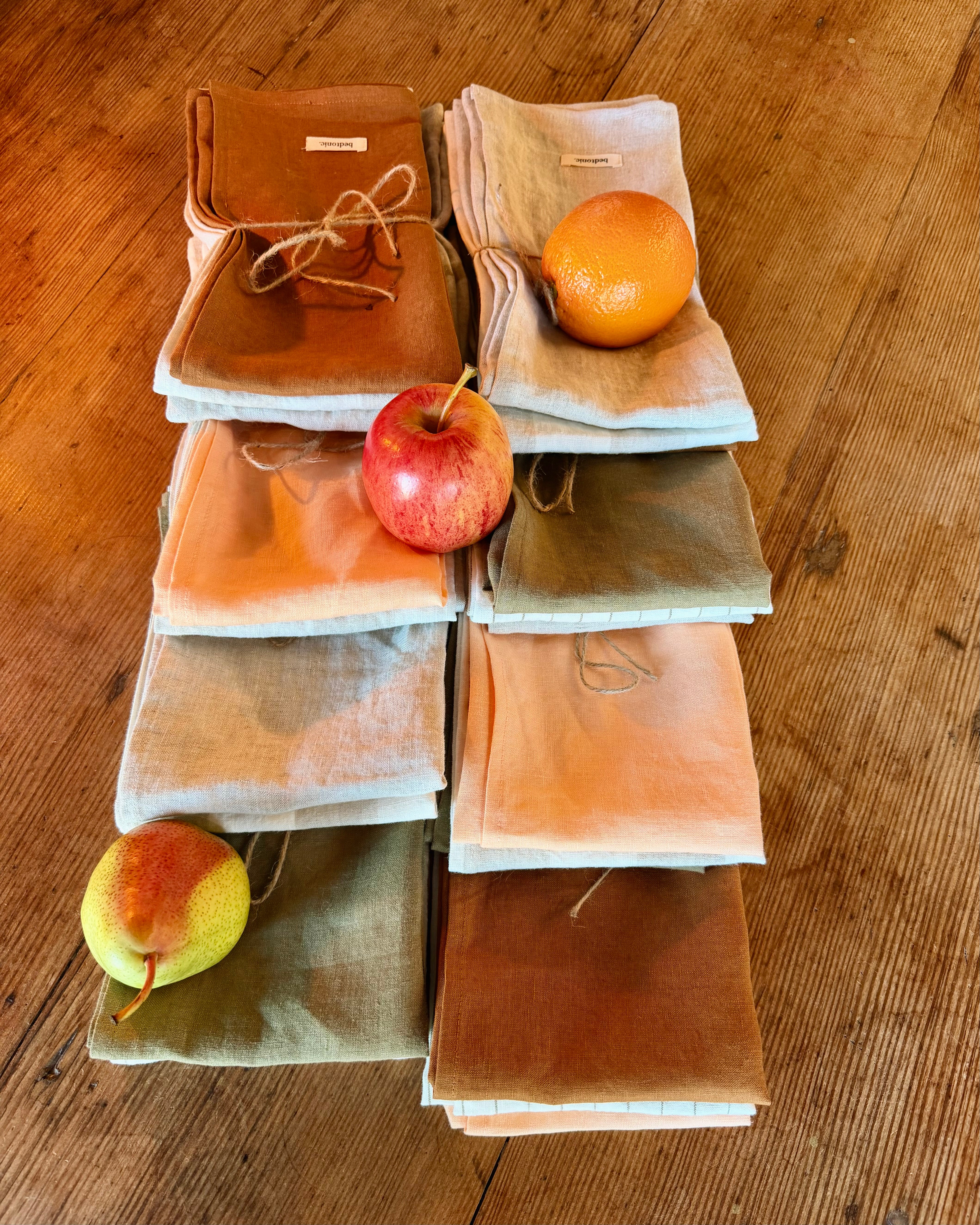 Linen tea towel set in peach, terracotta, olive, and natural with striped edges
