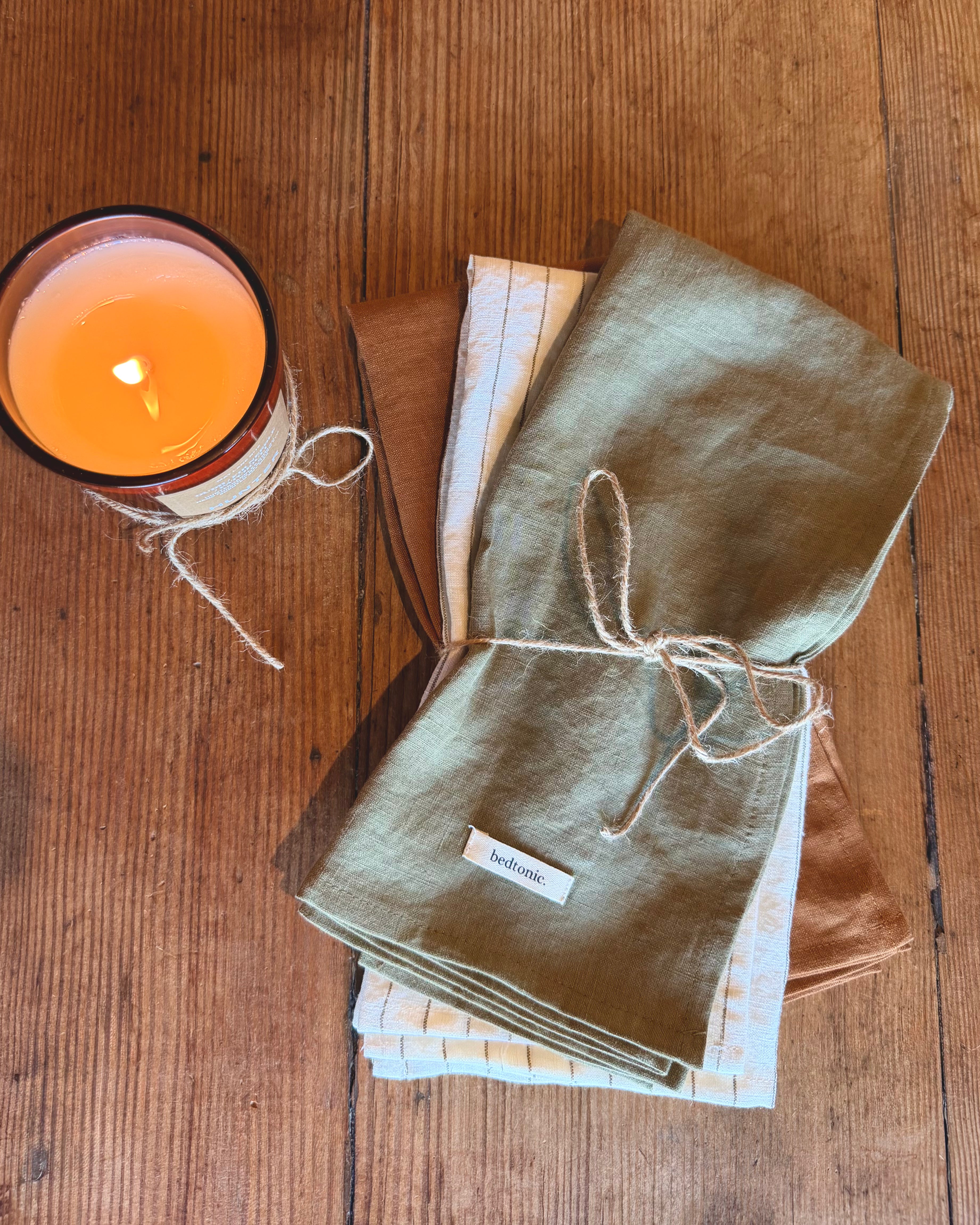 Tea towel set of folded linen in sage green, light blue stripes, and light tan