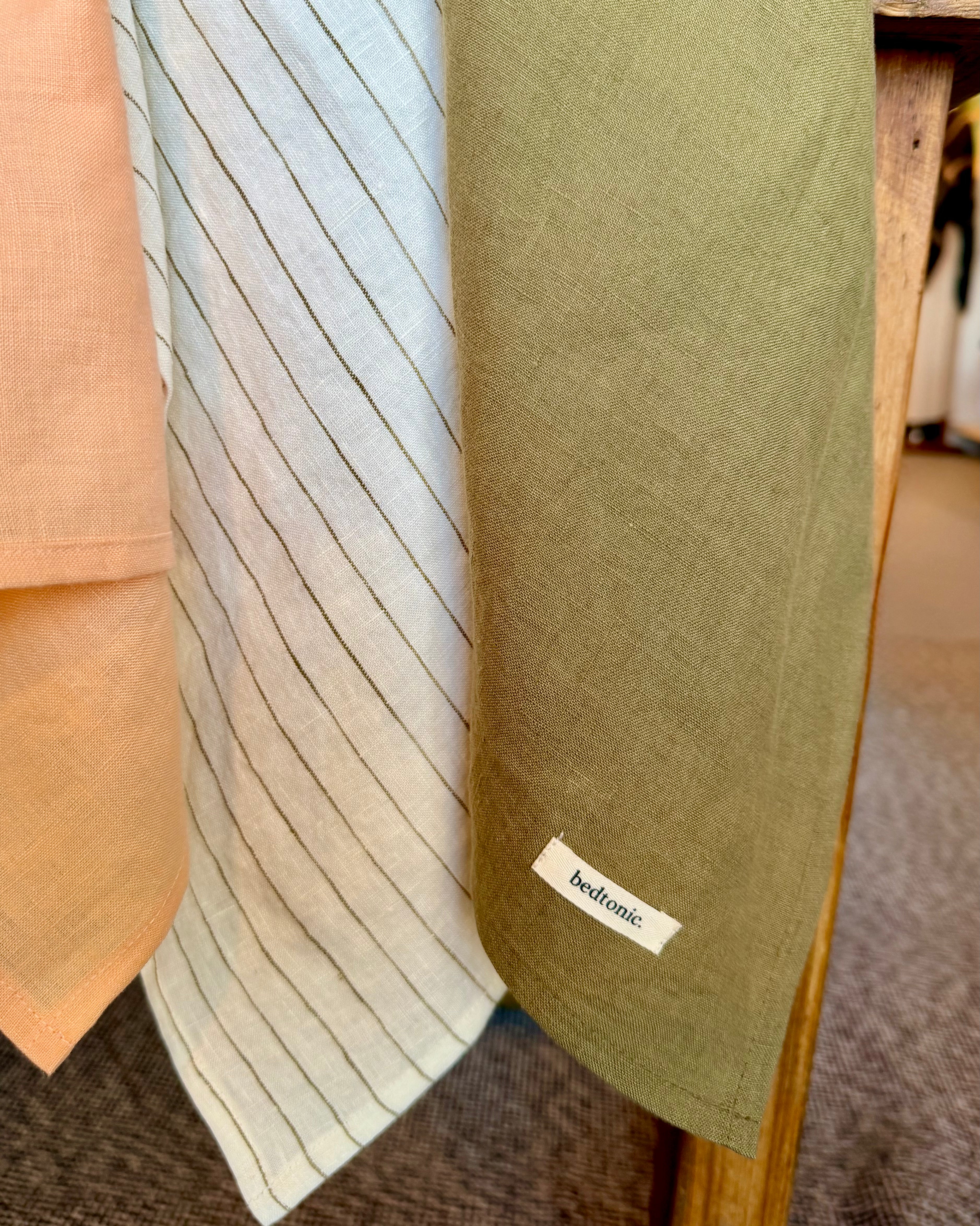 Linen tea towel set piece in light blue with thin vertical stripe and logo label