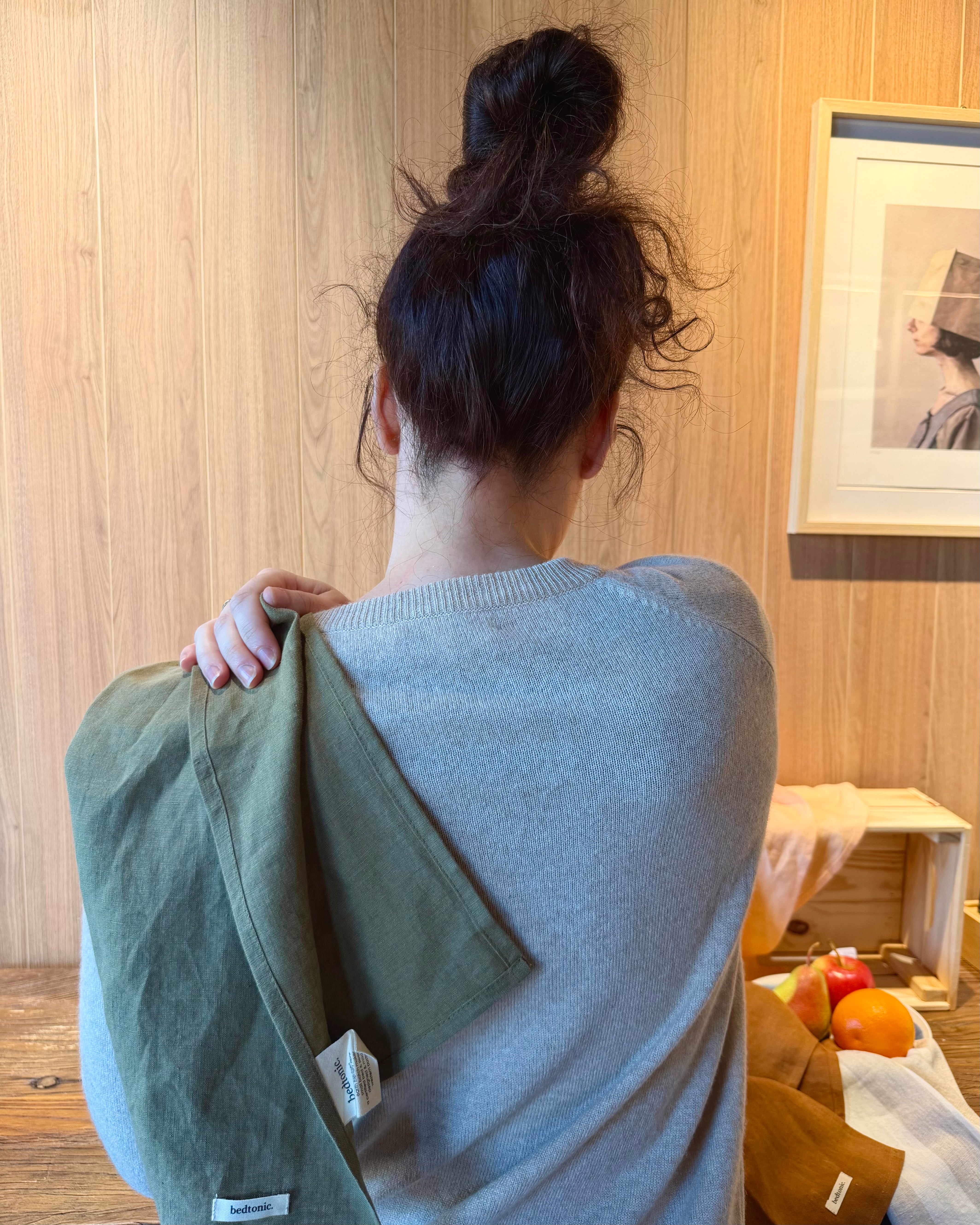 Back view of linen towel wrap, solid sage-green with small brand label