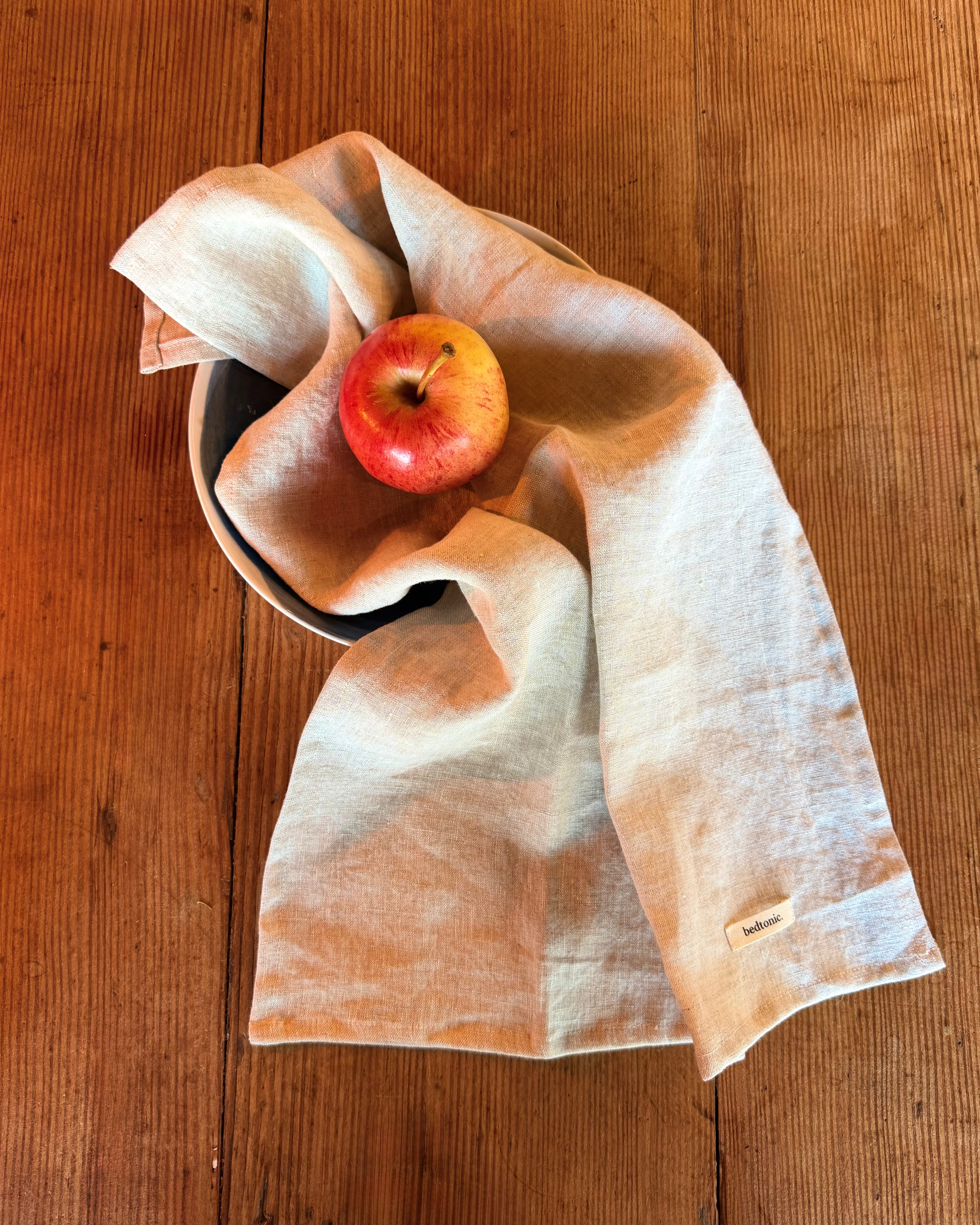 Linen tea towel set piece in natural beige with small logo label and stitched edge