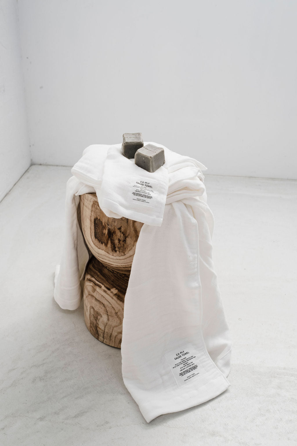 2 bars of soap with bedtonic engraved on them on a pile of white towels 